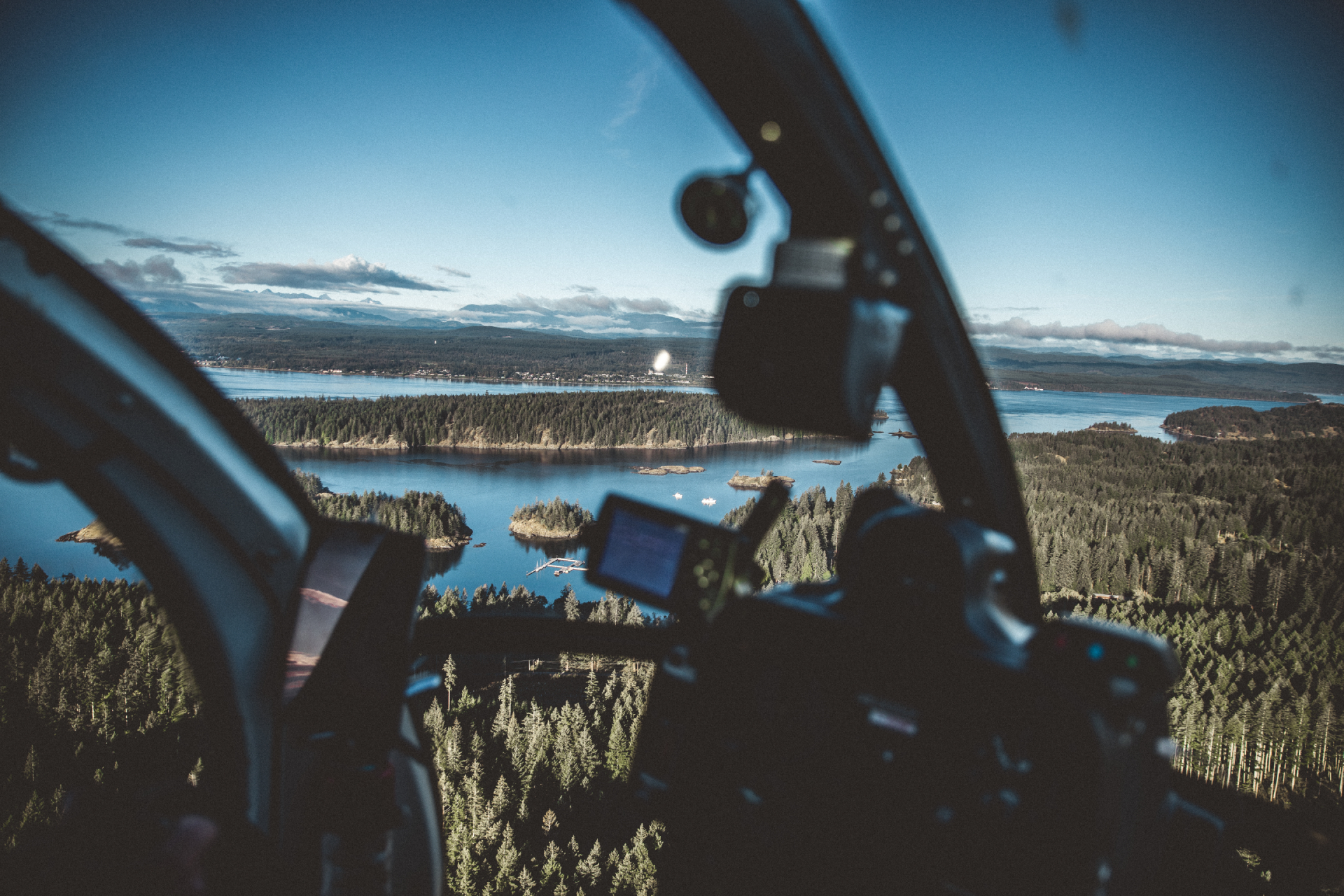 Helicopter flying over glaciers and remote wilderness
